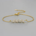 Bracelet doré à chaînons fins, motif feuillage avec zircons marquise scintillants
