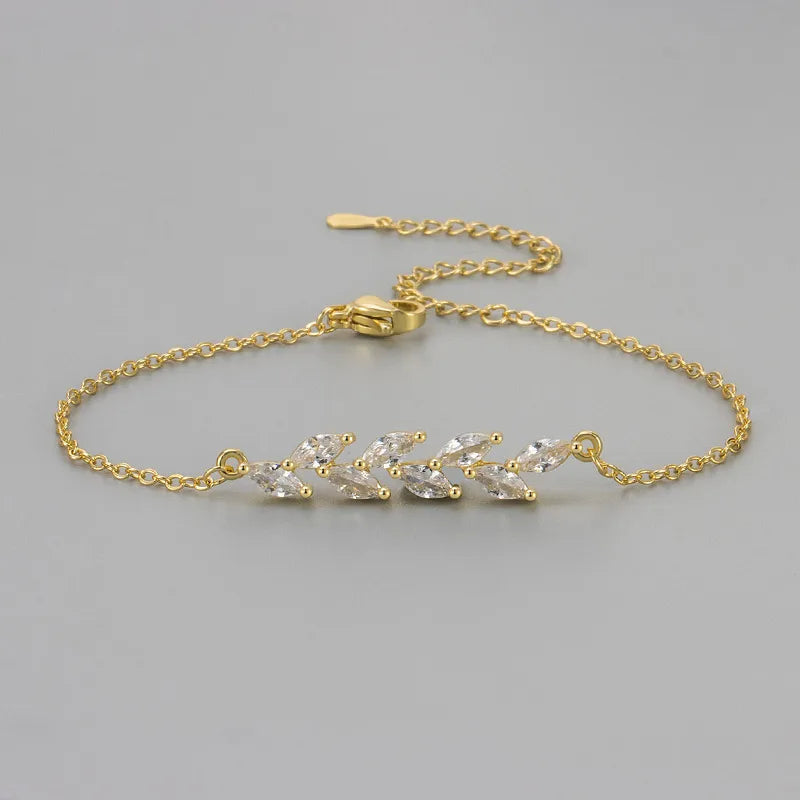 Bracelet doré à chaînons fins, motif feuillage avec zircons marquise scintillants