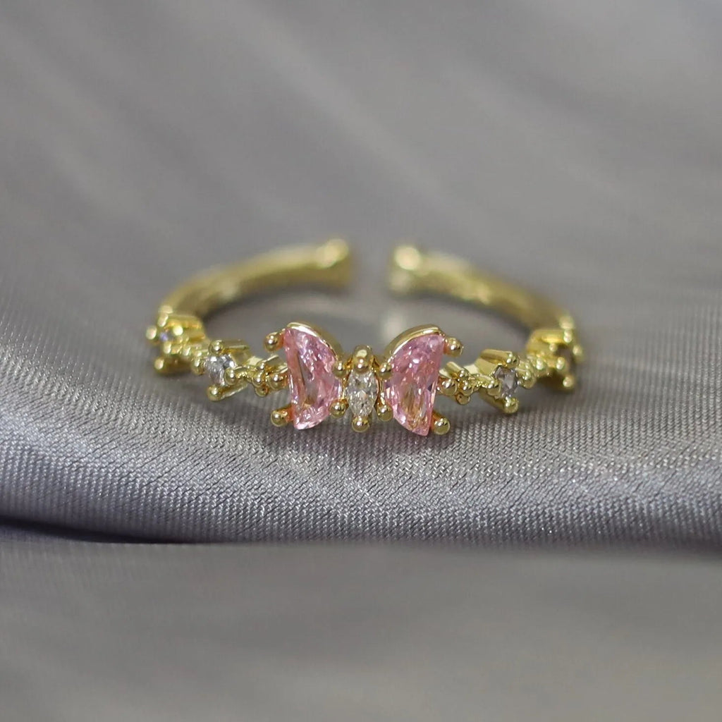 Bague ajustable papillon rose, cabochons roses et zirconiums, monture dorée