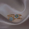 Bague ajustable double rang, fleurs bleues et turquoise, finition plaqué or 18K.