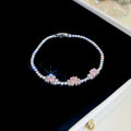 Bracelet rivière en acier argenté, rang de pierres rose pâle et transparentes