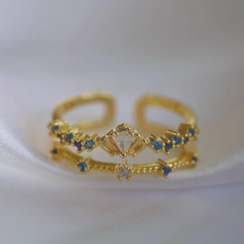 Bague dorée plaqué or double rang, saphirs bleus et pierre centrale claire, ajustable