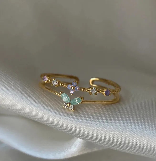 Bague double rang plaquée or, papillon serti de zircon vert pastel et pierres mauves