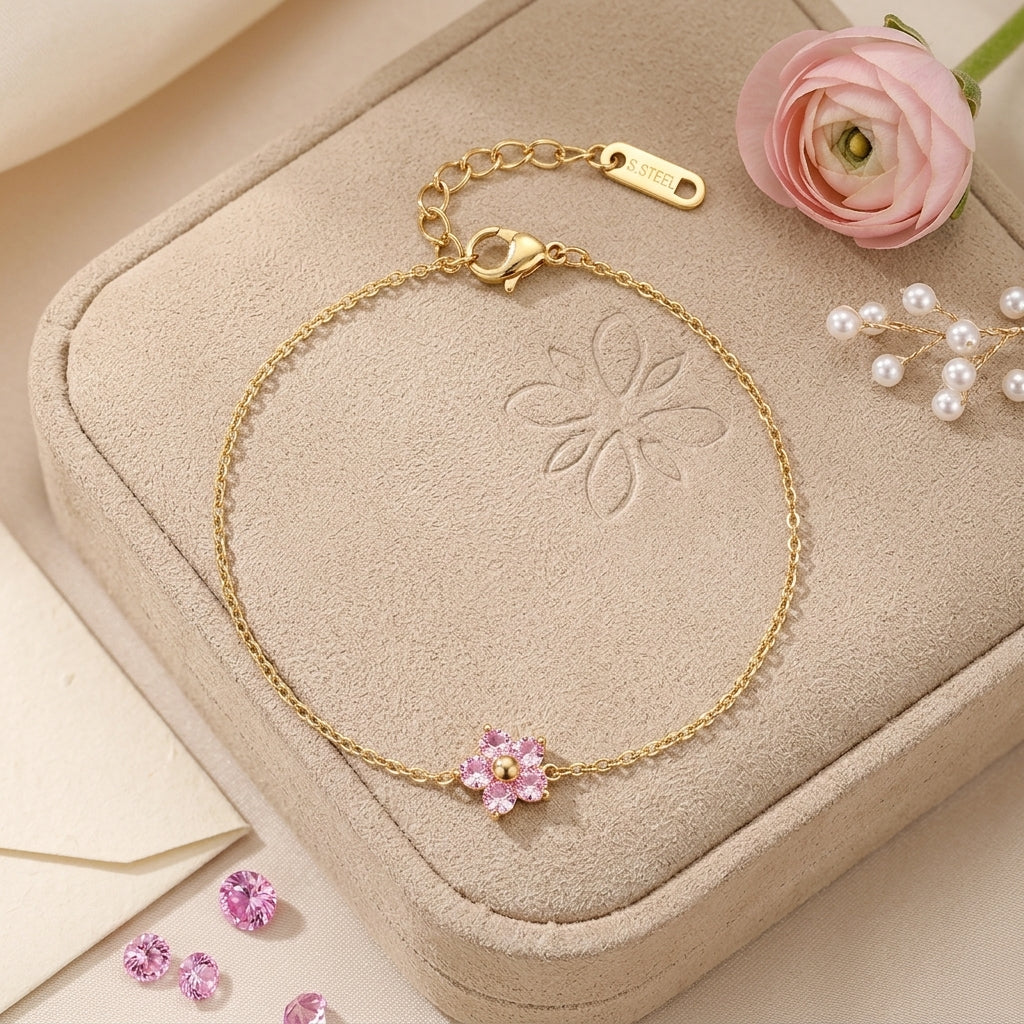 Bracelet plaqué or à breloque fleur rose en cristaux, fermoir marqué «STEEL»