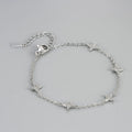 Bracelet argent à chaîne fine, étoiles serties de zircons, fermoir mousqueton.