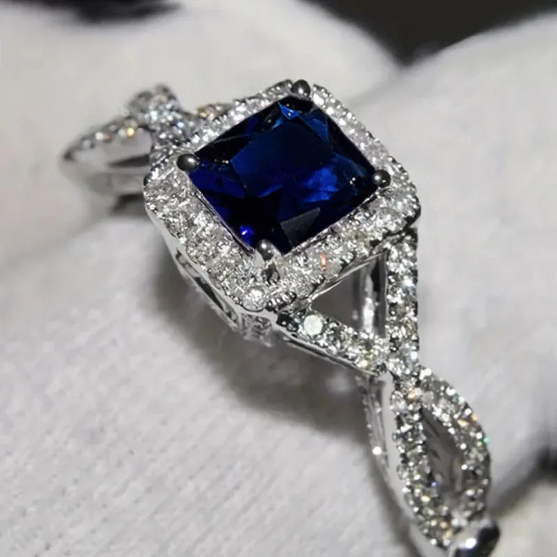 Bague solitaire carrée en acier argenté, halo de pierres, zircon bleu, anneau entrelacé.