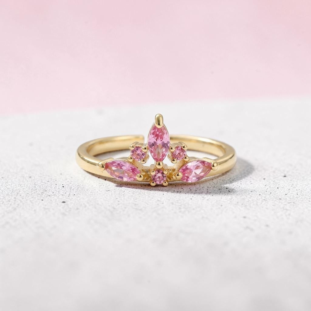 Bague couronne Jewelry by Kitana en acier inoxydable doré avec zircons roses éclatants, design ajustable et élégant.
