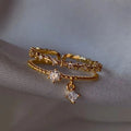 Bague Jewelry by Kitana ajustable double rang en acier inoxydable doré avec perles, zirconiums et pampille losange