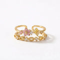 Bague plaquée or double rang, fleurs de pierres roses et claires, ajustable.
